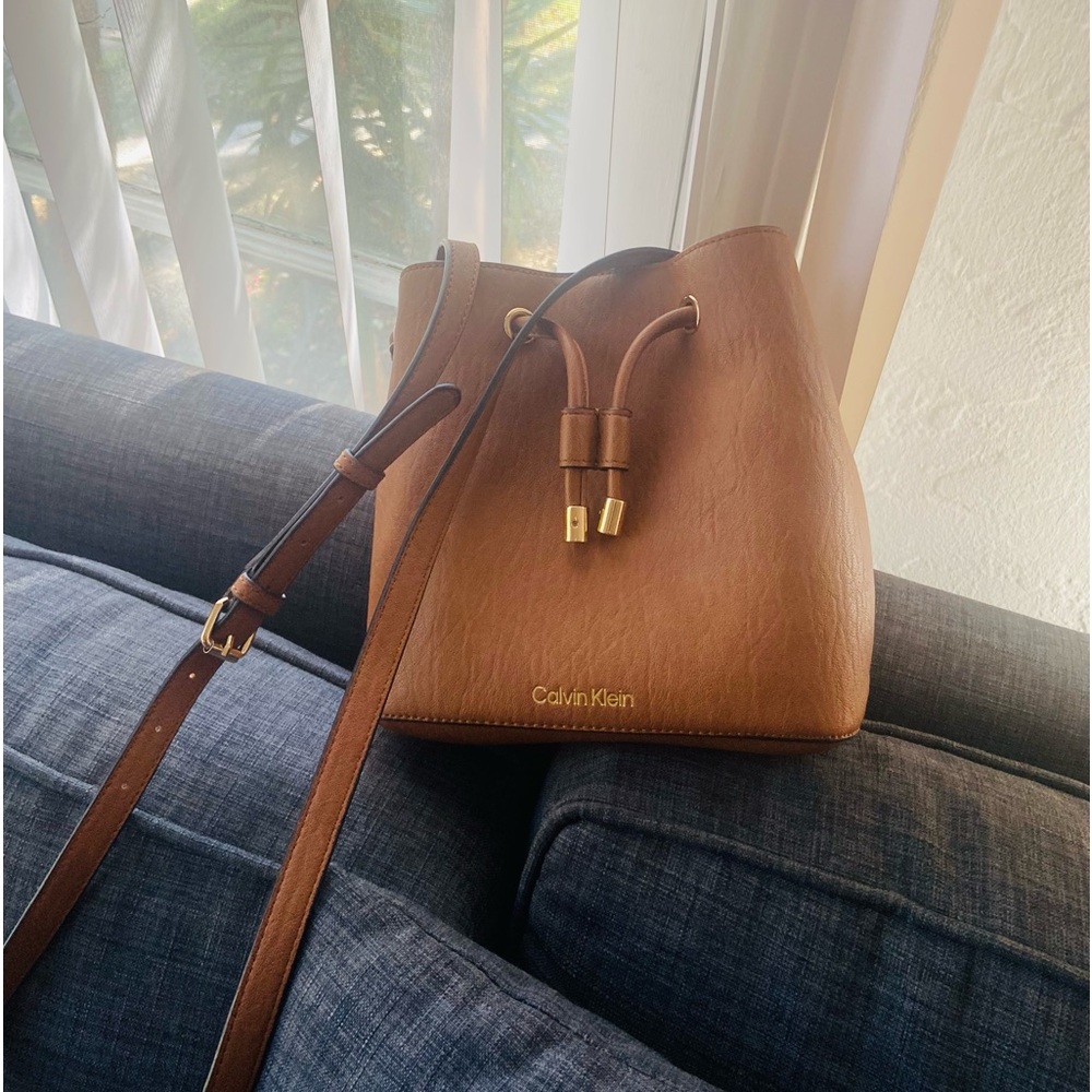 Small beautiful Calvin-Klein brown leather bag with red interior.
